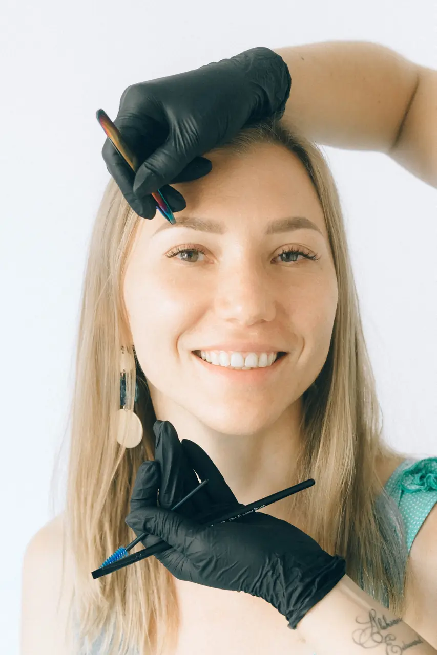 Brow artist mapping a client's eyebrows
